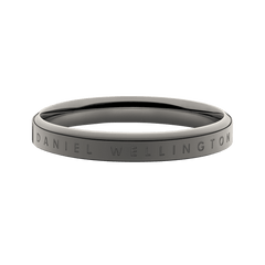 Classic Ring Graphite featuring a minimalist graphite-toned stainless steel band with engraved Daniel Wellington branding, shown in a close-up to highlight its smooth finish and modern silhouette.