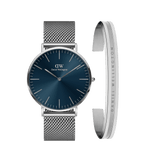 Classic Mesh Arctic + Elan Bracelet Silver set featuring a round watch with a deep blue dial and silver mesh strap, paired with a minimalist silver bracelet engraved with Daniel Wellington branding.