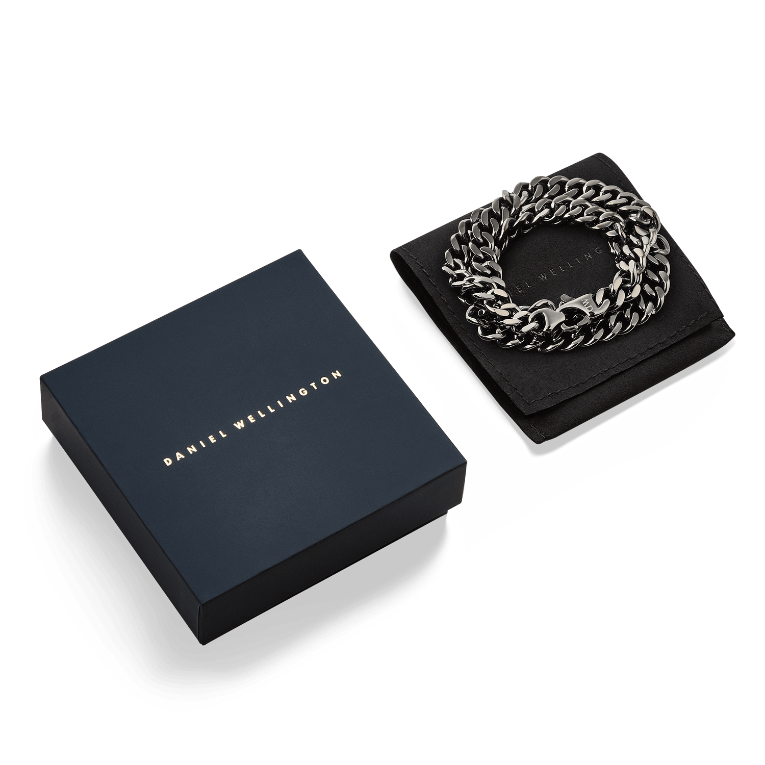 Ellipse Cuban Chain Necklace Graphite presented coiled on a black pouch next to a Daniel Wellington gift box, highlighting its bold links and matte graphite finish.
