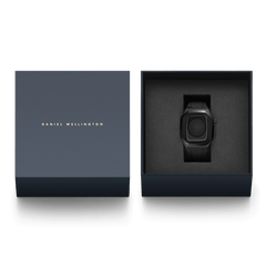 Switch Black Black Apple Watch case presented in a premium Daniel Wellington gift box, featuring a brushed stainless steel frame and integrated FKM rubber strap for Series 6, 5, 4, and SE models.