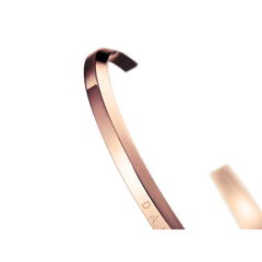 Close-up of the Classic Bracelet Rose Gold by Daniel Wellington, showing its polished PVD plated rose gold finish and minimalist open cuff design.