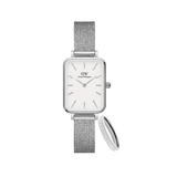 Rectangular Daniel Wellington Quadro Pressed Eggshell White watch with a silver mesh strap, paired with a Classic Ring Silver featuring polished stainless steel and subtle branding, both showcasing minimalist design and elegant styling.