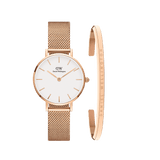 Rose gold Daniel Wellington Petite Melrose watch with a white dial and mesh strap, paired with a slim rose gold Classic Bracelet engraved with the Daniel Wellington logo, both featuring minimalist design suitable for petite wrists.