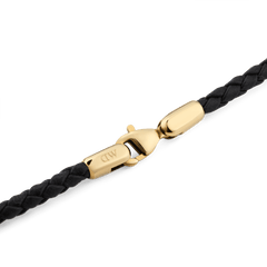 Detailed view of the Daniel Braided Leather Bracelet Sheffield 2.8 Gold, featuring a tightly woven black leather band and a polished gold-plated stainless steel clasp with a secure lobster closure.