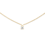 A delicate gold necklace featuring a fine chain and a single petite white cubic zirconia solitaire pendant, designed for a minimalist and elegant look.