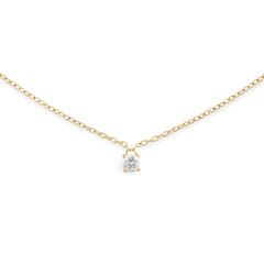 A delicate gold necklace featuring a fine chain and a single petite white cubic zirconia solitaire pendant, designed for a minimalist and elegant look.