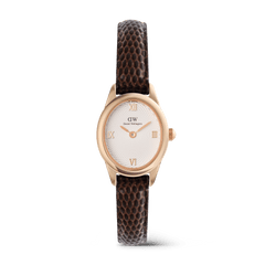Ladies rose gold watch with a petite oval case, white guilloché dial, Roman numeral markers, and a dark brown lizard-embossed leather strap, blending classic elegance with modern style.
