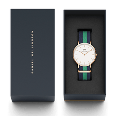 Classic Warwick Rose Gold watch with a navy and green NATO strap, presented in a Daniel Wellington gift box, highlighting its elegant packaging and suitability for gifting.