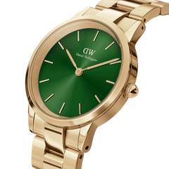 Close-up of the Iconic Link Emerald Gold watch, showing its polished gold stainless steel bracelet and a vibrant emerald green dial with minimalist gold hour markers and hands.