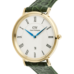 Close-up of the Classic Roman Numerals Date Dark Green Croc Belly Gold watch, featuring a gold-plated case, white dial with black Roman numerals, blue hands, date window, and a green crocodile-embossed leather strap.