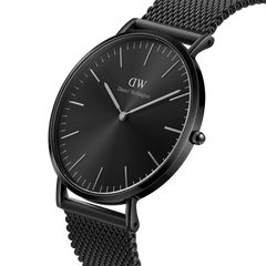 Classic Mesh Onyx Black watch with a 40mm black stainless steel case, minimalist black sunray dial, and a woven mesh bracelet, shown from a side angle to highlight its slim profile and modern monochrome design.