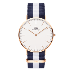 Classic Glasgow Rose Gold watch with a round rose gold case, minimalist white dial, and a blue and white striped polyester NATO strap, blending timeless elegance with a nautical-inspired design.