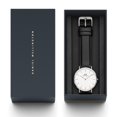 Classic Sheffield Silver watch with a black leather strap and minimalist silver case, presented in a sleek Daniel Wellington gift box with the lid placed alongside.