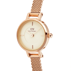 Close-up of the Petite Mini Champagne Melrose watch, showcasing its champagne dial, minimalist hour markers, and rose gold mesh strap with polished detailing.