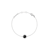A delicate silver bracelet featuring a slim adjustable chain and a round black agate centrepiece framed by sparkling white cubic zirconia, designed for a refined and timeless look.