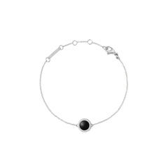 A delicate silver bracelet featuring a slim adjustable chain and a round black agate centrepiece framed by sparkling white cubic zirconia, designed for a refined and timeless look.
