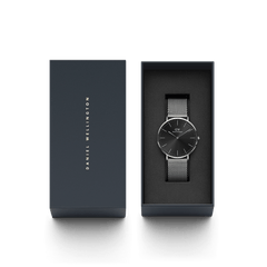 Classic Mesh Onyx silver watch with a black sunray dial and stainless steel mesh strap, elegantly presented in a Daniel Wellington branded gift box.