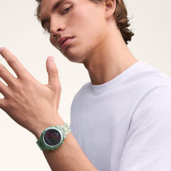 A man wearing the Daniel Wellington Retro Digital Light Green Light Green watch, showcasing its transparent light green strap and bold black digital dial, styled with a casual white T-shirt for a modern, everyday look.