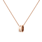 Close-up of the Emalie Necklace Rose Gold Satin White, showing a polished rose gold chain and a smooth satin white enamel pendant with engraved detailing, ideal for adding a modern, elegant touch to any look.
