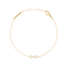 Delicate gold chain bracelet featuring an infinity symbol set with sparkling white cubic zirconia crystals, adjustable in length with a secure lobster clasp.