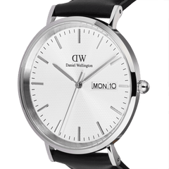 Close-up of the Classic Day Display Sheffield Silver watch showing the textured white dial, day and date window, polished silver stainless steel case, and black leather strap.