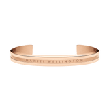 Minimalist Elan Bracelet Rose Gold by Daniel Wellington, featuring a warm rose gold tone, engraved logo, and open cuff style suitable for both men and women.