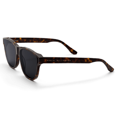 Ambler Bio-Acetate Dark Havana sunglasses featuring a rectangular tortoiseshell frame, dark UV400 lenses, and the Daniel Wellington logo on the arm, designed for women seeking both style and sun protection.