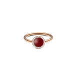 Rose gold ring featuring a domed red agate stone at the centre, encircled by a halo of white cubic zirconia crystals on a slim, polished band.