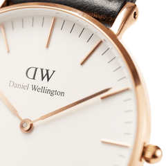 Detail of the Classic Southampton watch featuring a rose gold case, minimalist white dial with rose gold hands and markers, and a black leather strap.