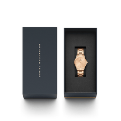 Iconic Link Unitone RG rose gold ladies watch with a polished link bracelet, presented in a sleek black Daniel Wellington gift box, ideal for gifting or adding to your collection.