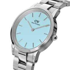 Close-up of the Iconic Link Capri women’s watch, showcasing its polished stainless steel bracelet and pastel blue dial with minimalist silver hour markers.