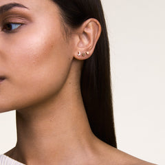 Heart Stud Rose Gold earring worn in a second piercing, styled with other rose gold studs for a delicate, modern look suitable for everyday wear.