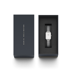 Quadro Pressed Sterling presented in its branded gift box, featuring a minimalist rectangular silver watch with a mesh strap, ideal for gifting or adding to a personal collection.