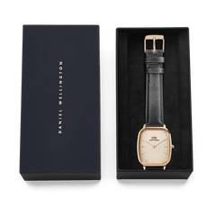 Marlon Sheffield Linen Gold men's watch presented in a Daniel Wellington gift box, featuring a cushion-shaped gold case, linen-textured dial, and classic black leather strap, ideal for gifting or adding to a collection.