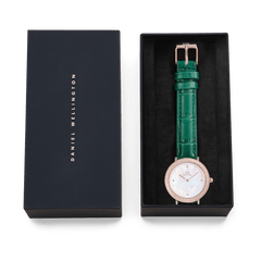 Crystalline Bezel Green Croc Rose Gold ladies watch presented in a Daniel Wellington gift box, featuring a rose gold-plated case, crystal-set bezel, white mother of pearl dial, and emerald green crocodile-embossed leather strap.