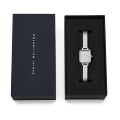 Quadro Mini Reflection Silver watch with a slim rectangular case and polished mesh strap, presented in an elegant Daniel Wellington gift box, ideal for gifting or adding to your collection.