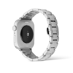 Smartwatch Iconic Link Silver strap attached to an Apple Watch, highlighting the brushed and polished stainless steel links and butterfly buckle from the back view.