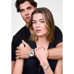 The Mirelle Infinity Necklace Silver is worn layered with other jewellery, showcasing its delicate infinity pendant with white cubic zirconia crystals on a fine silver chain, styled for an elegant everyday look.