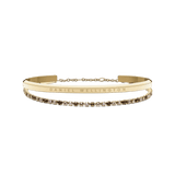Classic Bracelet Gold & Tennis Bracelet Honey Combo Gold featuring a slim polished gold cuff engraved with Daniel Wellington and a delicate tennis bracelet with honey-coloured stones set in a gold chain, displayed side by side.