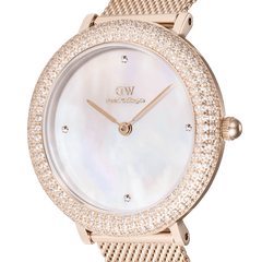 Close-up of the Crystalline Bezel Melrose rose gold ladies watch, highlighting its double row of sparkling crystals around the bezel, white mother of pearl dial with four crystal markers, and elegant rose gold mesh strap.