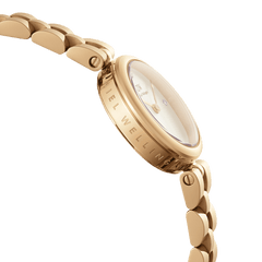 Close-up side view of the Elan Lumine Gold watch, showing the engraved Daniel Wellington branding on the gold case, crystal-accented white dial, and the polished three-link gold bracelet.