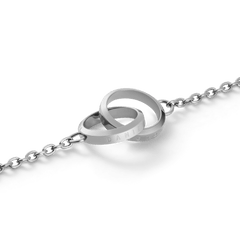 Close-up of the Elan Unity Bracelet Silver showing two polished interlocking rings as the pendant on a fine silver chain, crafted in stainless steel for a modern, elegant finish.