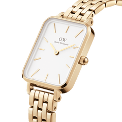 Quadro 5-Link Evergold watch featuring a rectangular gold case, minimalist white dial, and a polished 5-link gold bracelet, shown in a close-up angle highlighting its refined details.