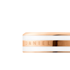 Close-up of the Daniel Wellington Emalie Ring Satin White Rose Gold, highlighting the engraved branding on the polished rose gold band with a satin white enamel finish and minimalist design.