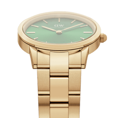 Detail view of the Iconic Link Emerald Gold watch showing its brushed gold stainless steel bracelet and the edge of the emerald green dial with minimalist gold markers.