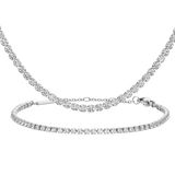 Silver tennis bracelet and necklace set featuring rows of sparkling stones in polished silver, showcasing a cohesive and elegant design suitable for everyday wear or special occasions.