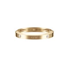 Classic Lumine Ring Gold featuring a slim, polished gold band with sparkling crystal accents and engraved logo detail, designed for stacking or wearing solo.