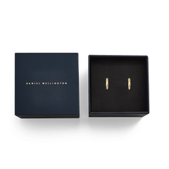 Arch Earring Gold 12mm presented in an elegant navy Daniel Wellington gift box, showcasing the pair of small gold hoop earrings with a minimalist, polished finish.