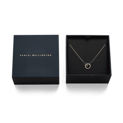 Audrey Necklace Black Agathe Gold displayed in an elegant Daniel Wellington gift box, featuring a gold chain and a black agate pendant surrounded by white cubic zirconia crystals.