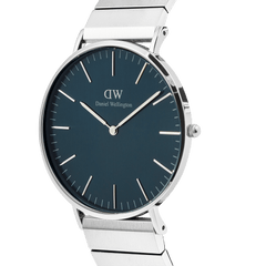 Classic Piano Link Arctic Silver watch with a brushed arctic blue dial, slim silver case, and geometric stainless steel piano link strap, shown from a side angle to highlight its minimalist design and polished finish.